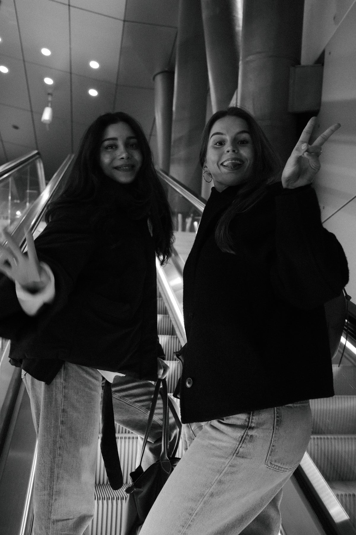The two MUSED founders posing on an escalator, black and white