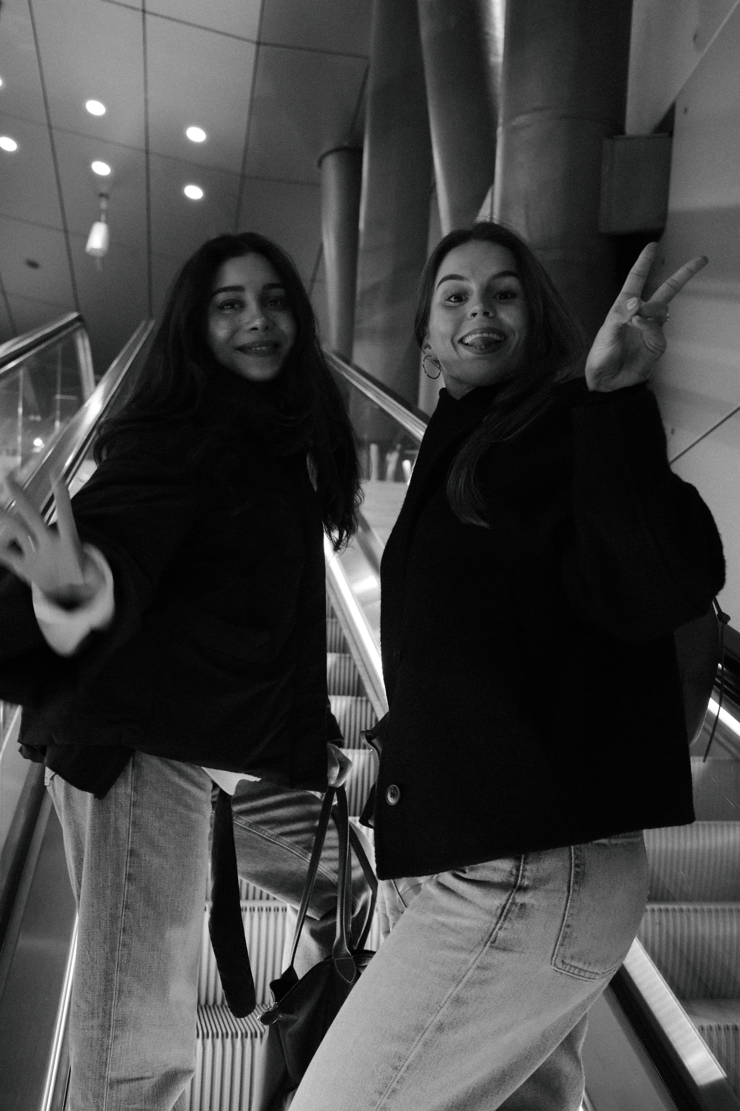 The two MUSED founders posing on an escalator, black and white