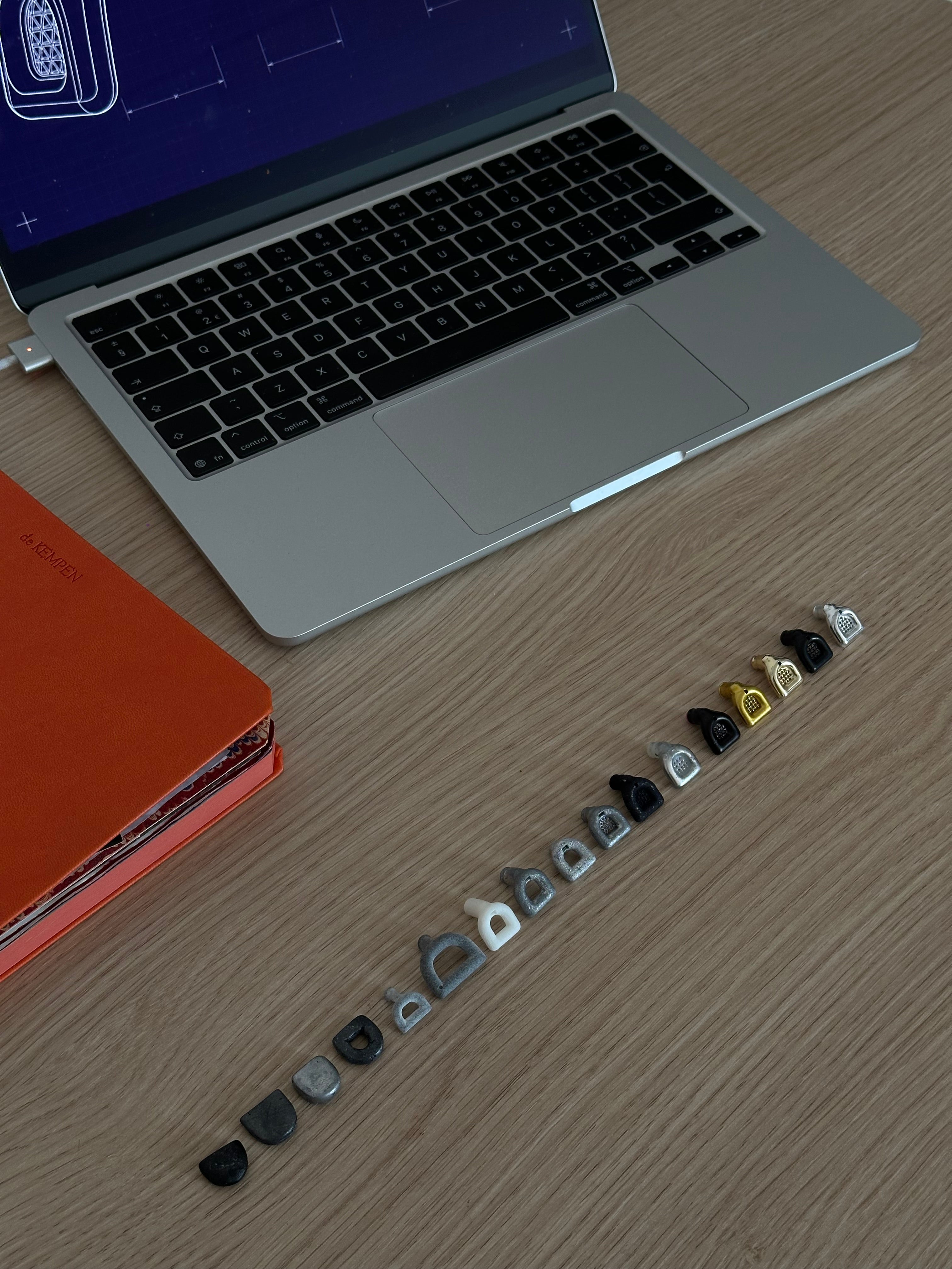 MUSED design desk with laptop, notebook and earplug prototypes